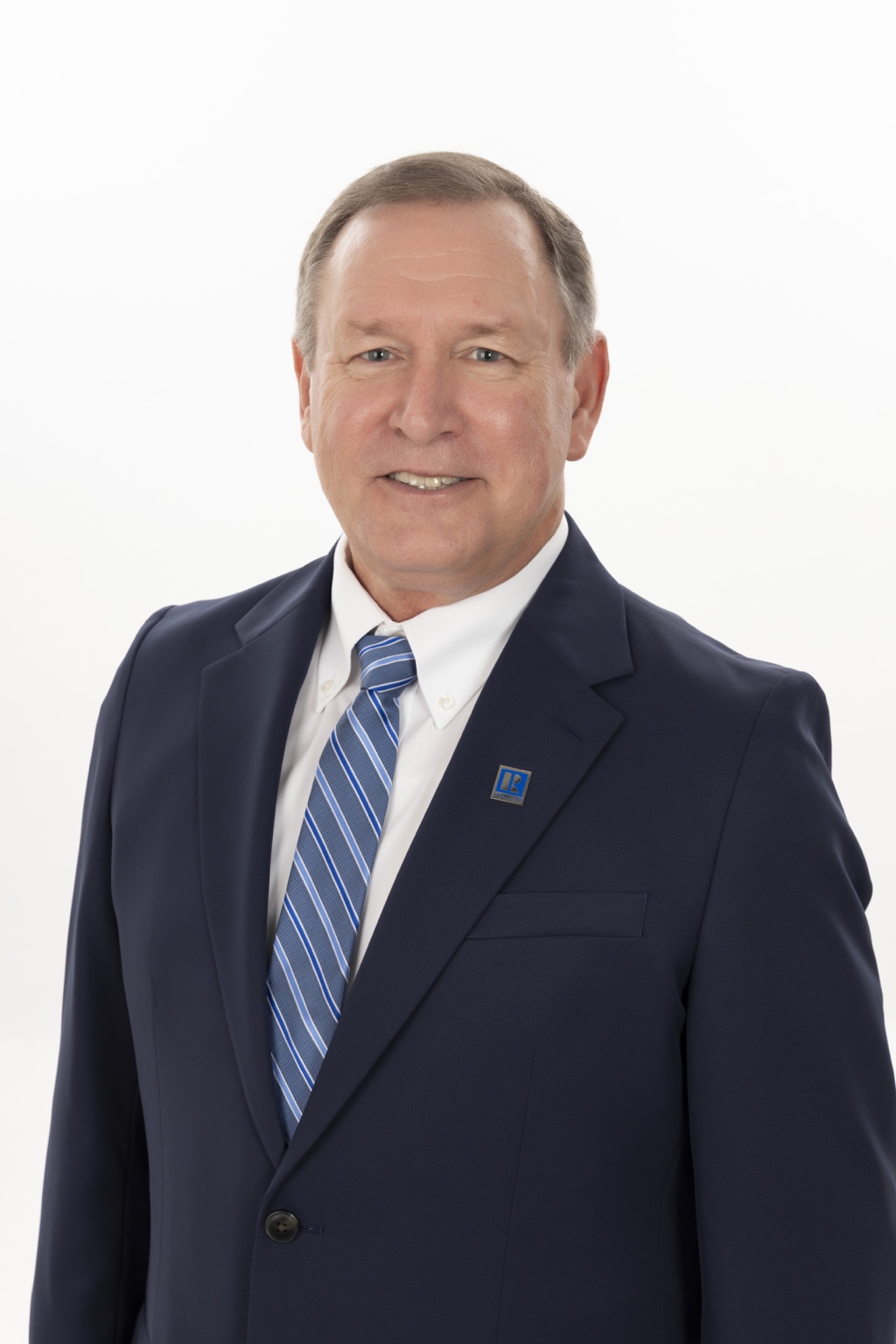 Wayne Horning, REALTOR®, in a navy suit